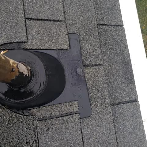 Close view of a pipe boot on a gray shingle roof, Karns