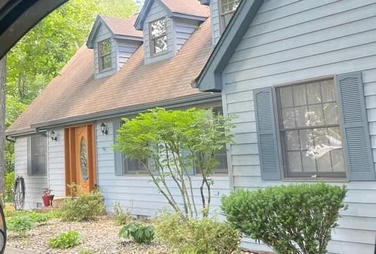 Cape cod house with blue siding and dormers, Loudon