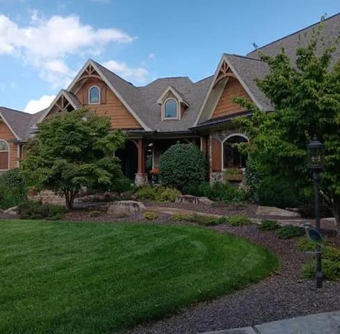 Craftsman-style house with stone accents and a landscaped yard, Louisville