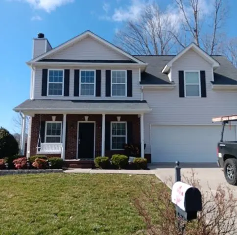 Two-story house with a brick front porch and white siding, Powell