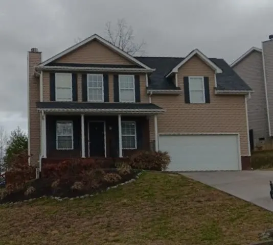 Two-story house with tan siding and a gray shingle roof, Powell