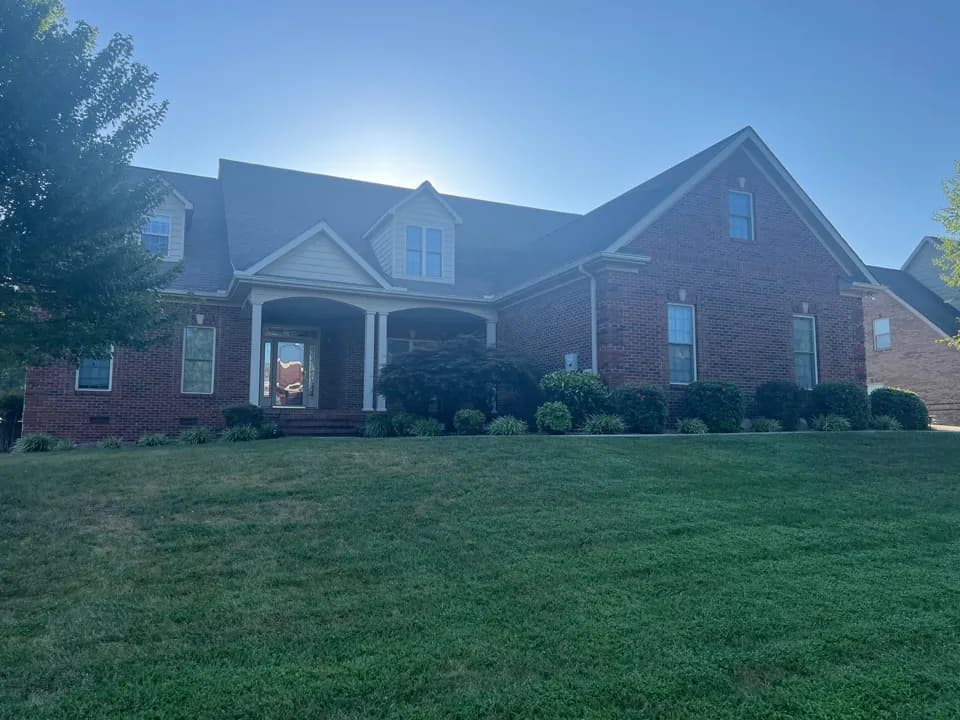 Brick house with dormers and a wide lawn, Maryville