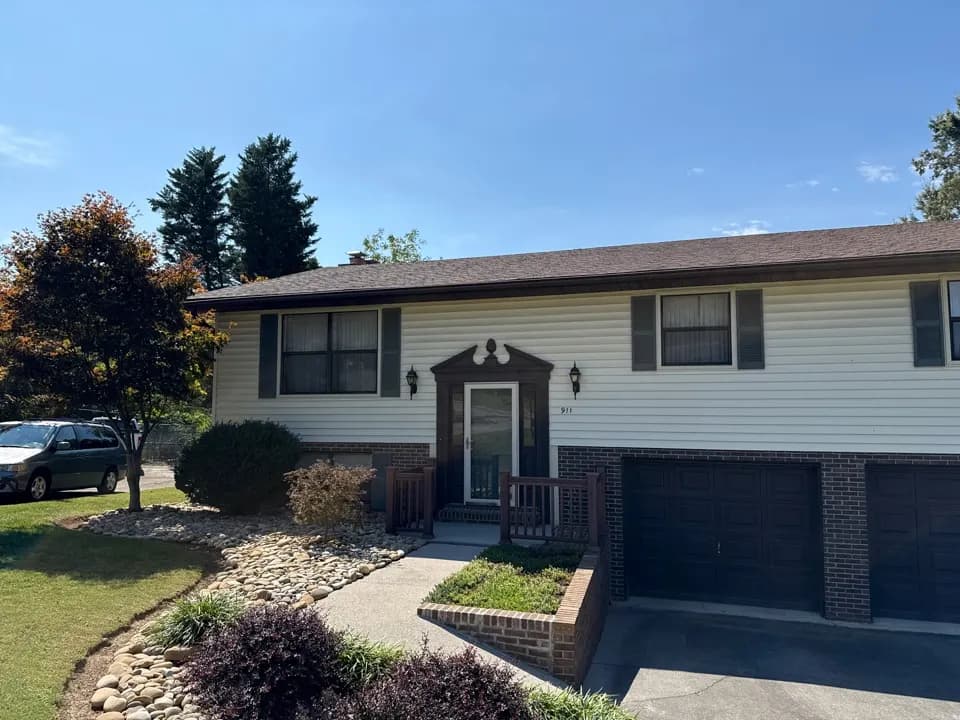 Split-level home after a shingle repair in Maryville, with popped nails sealed and loose shingles reattached