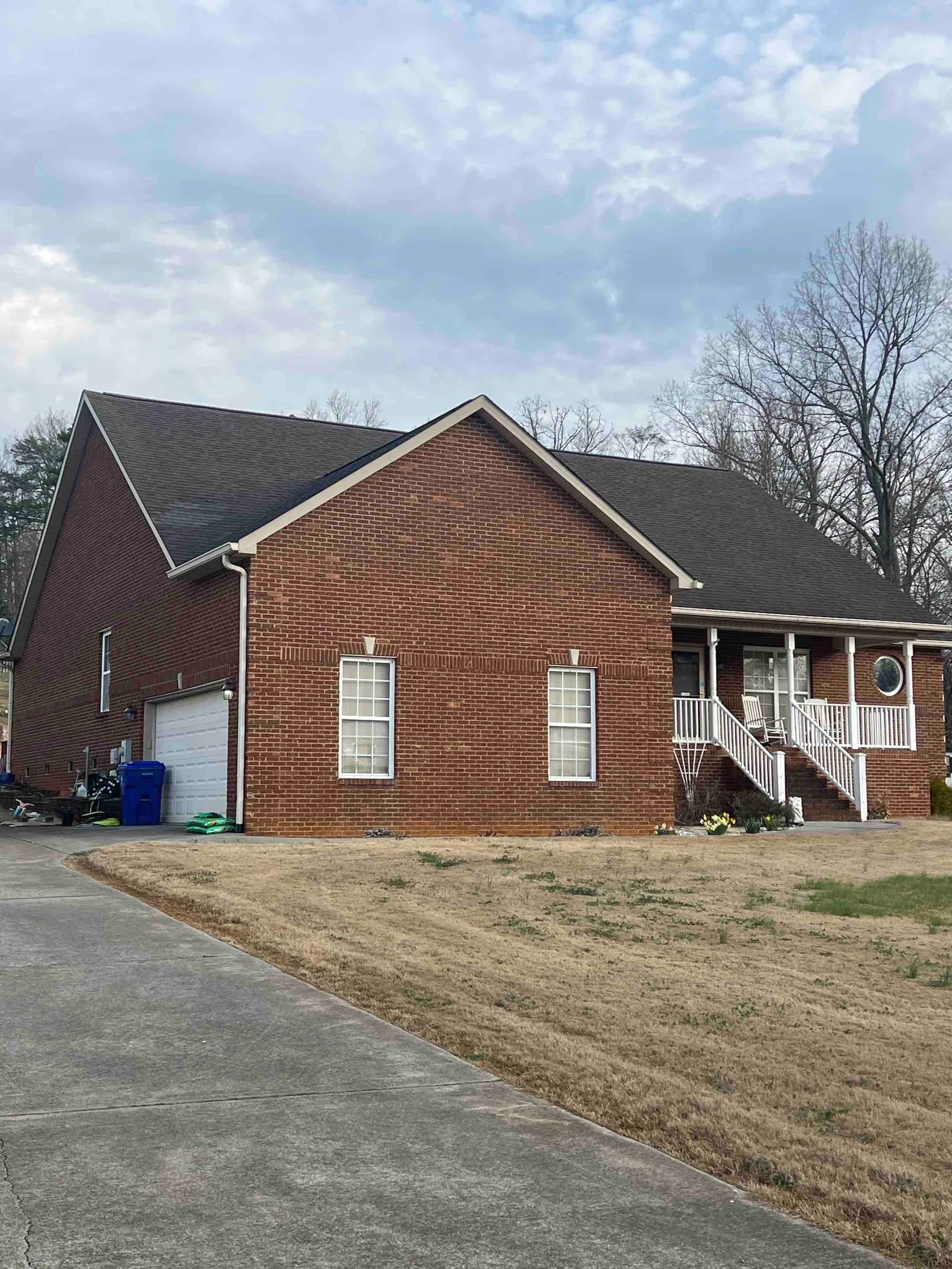 Brick ranch home with a new shingle roof, from a Maryville roof replacement