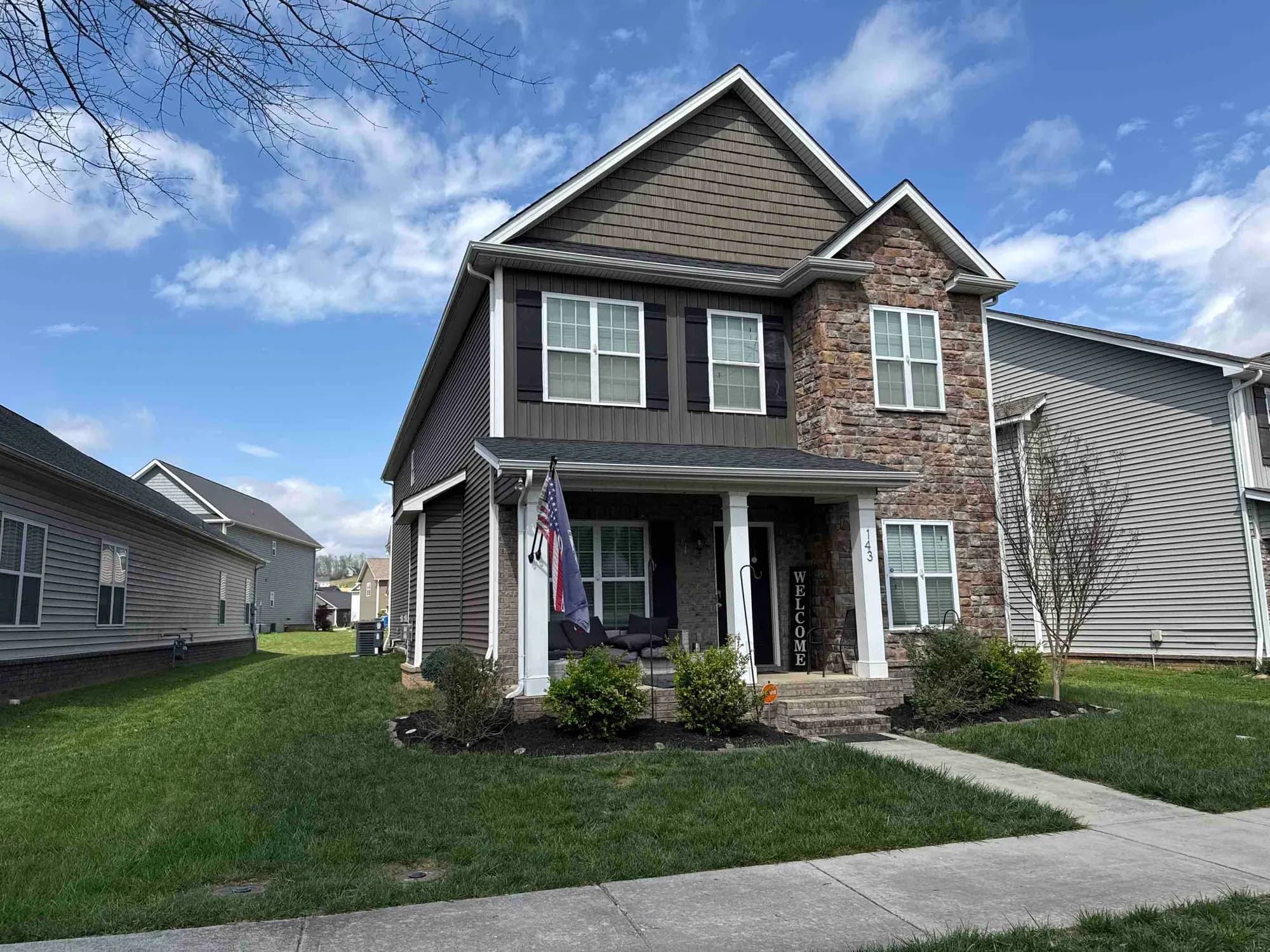 Two-story stone and siding home with a shingle roof in Oak Ridge, Tennessee, photographed at a free roof inspection