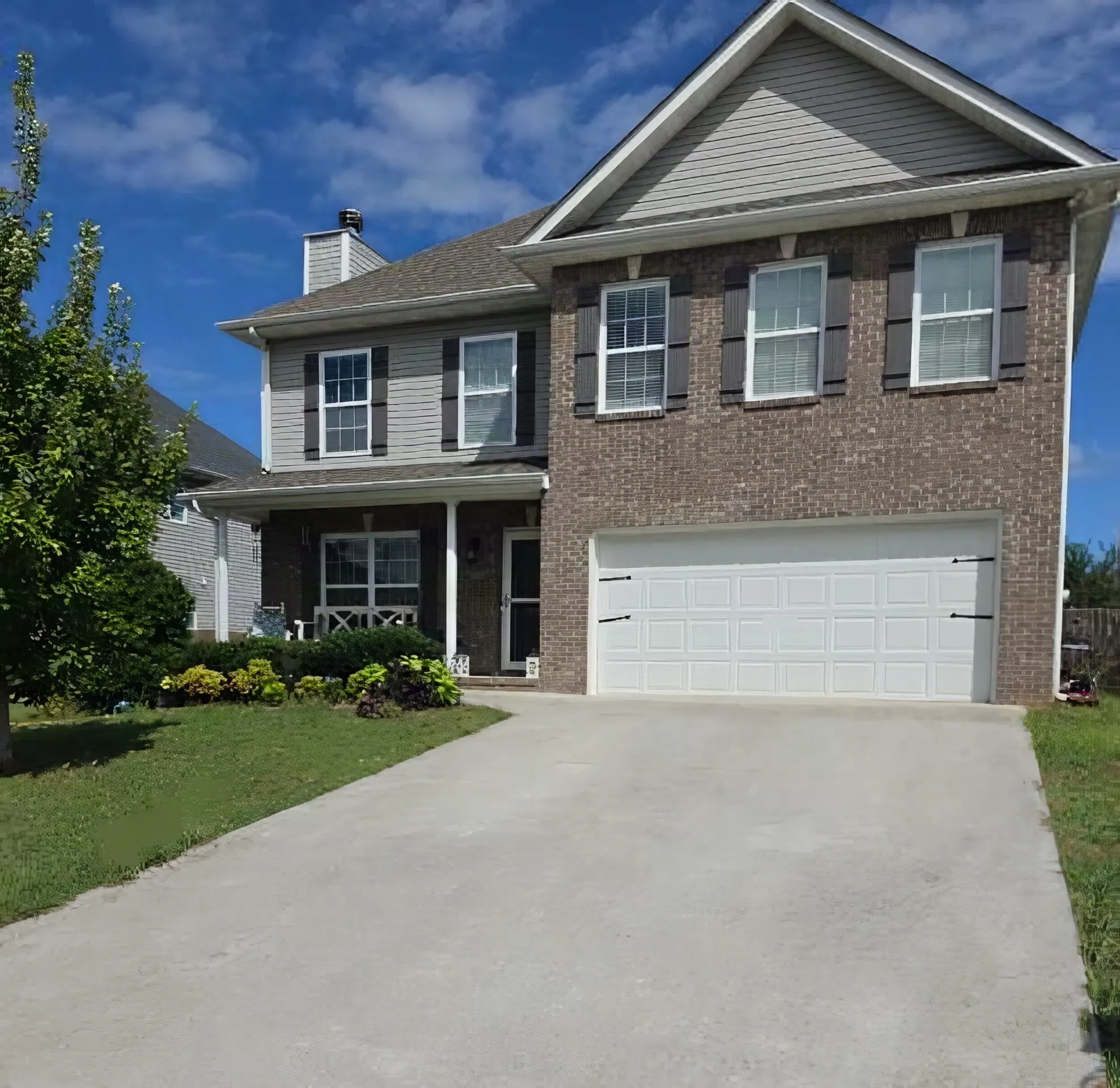 Two-story brick and siding home in Knoxville during a leaking pipe boot repair