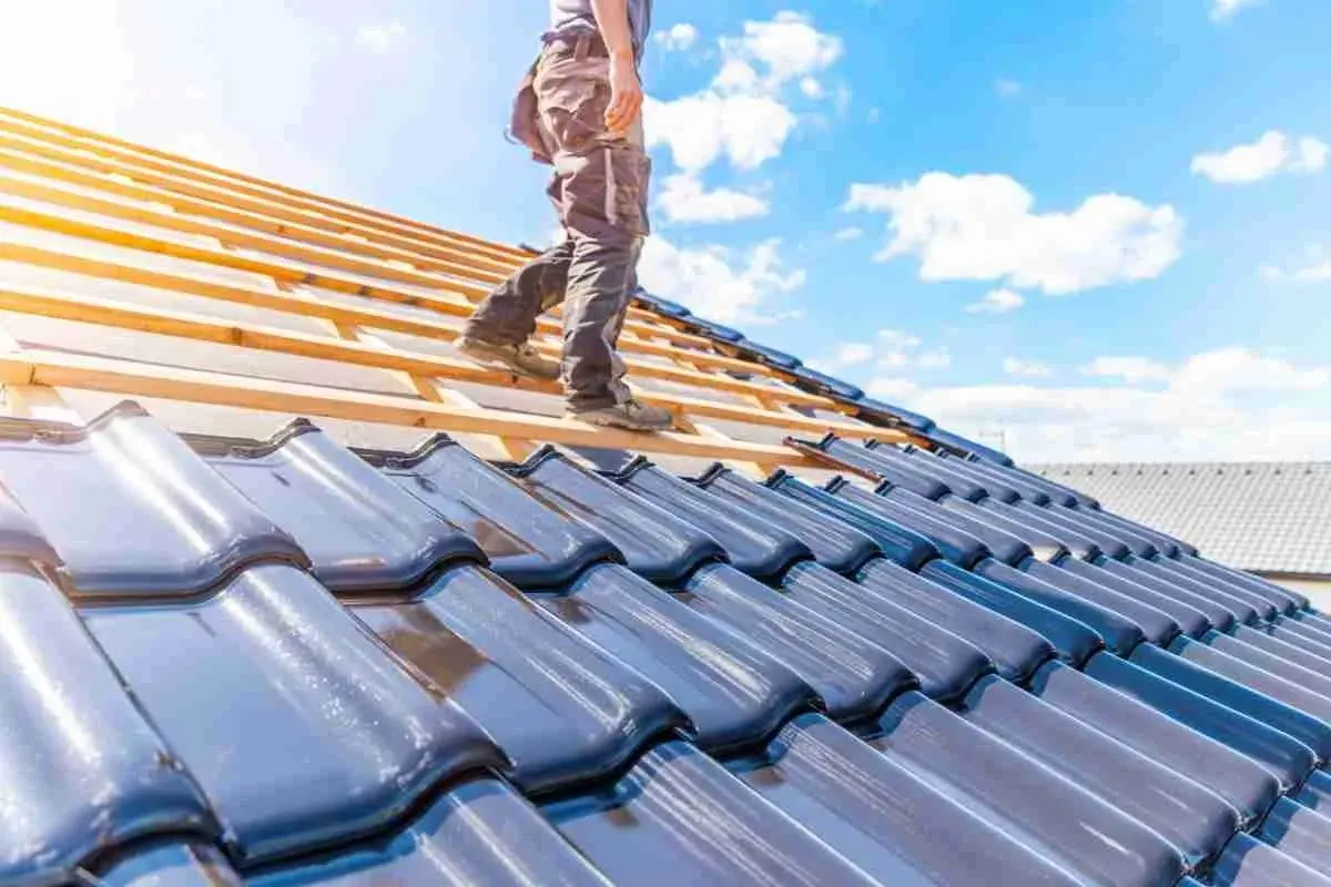Roofer walking on roof battens during a tile roof installation
