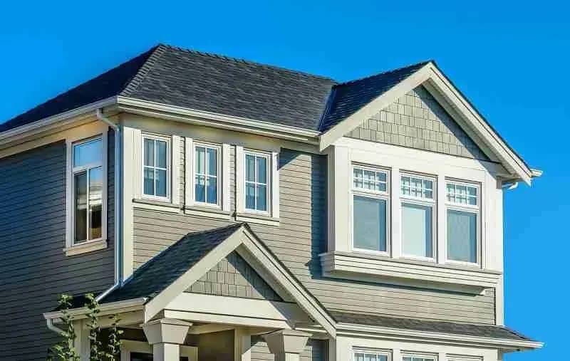 Two-story house with gray siding and a dark shingle roof