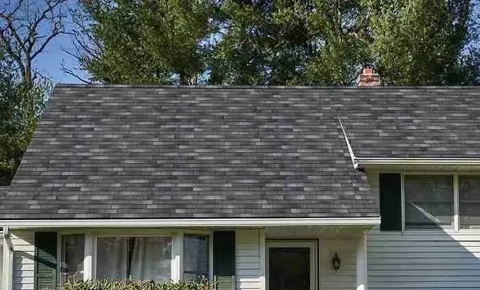 Gray shingle roof on a house with white siding