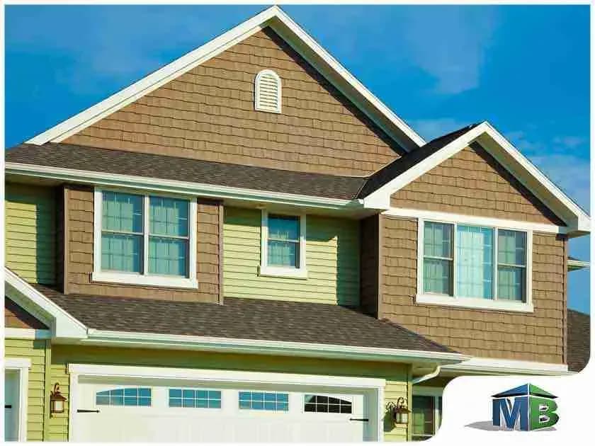 Two-story house with brown shake siding and green lap siding