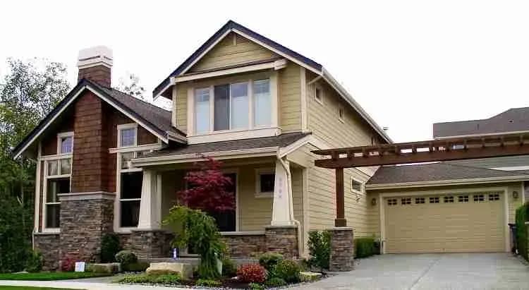 Two-story craftsman house with stone accents and a shingle roof