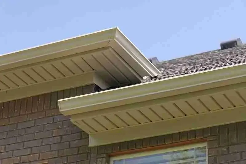 Soffit and fascia under a shingle roof edge on a brick house