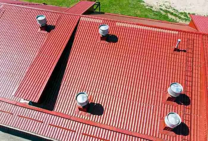Red metal roof with round vents