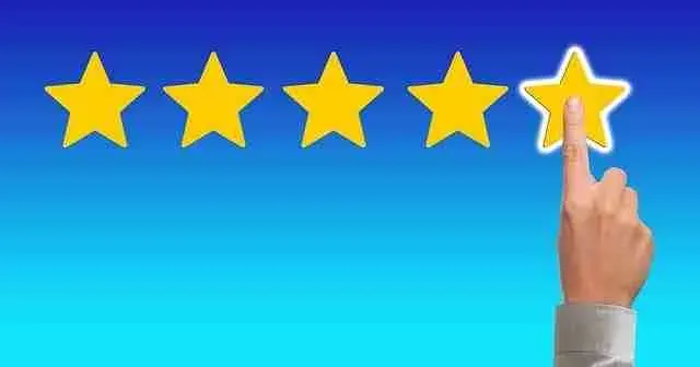 Hand touching the fifth star in a row of rating stars