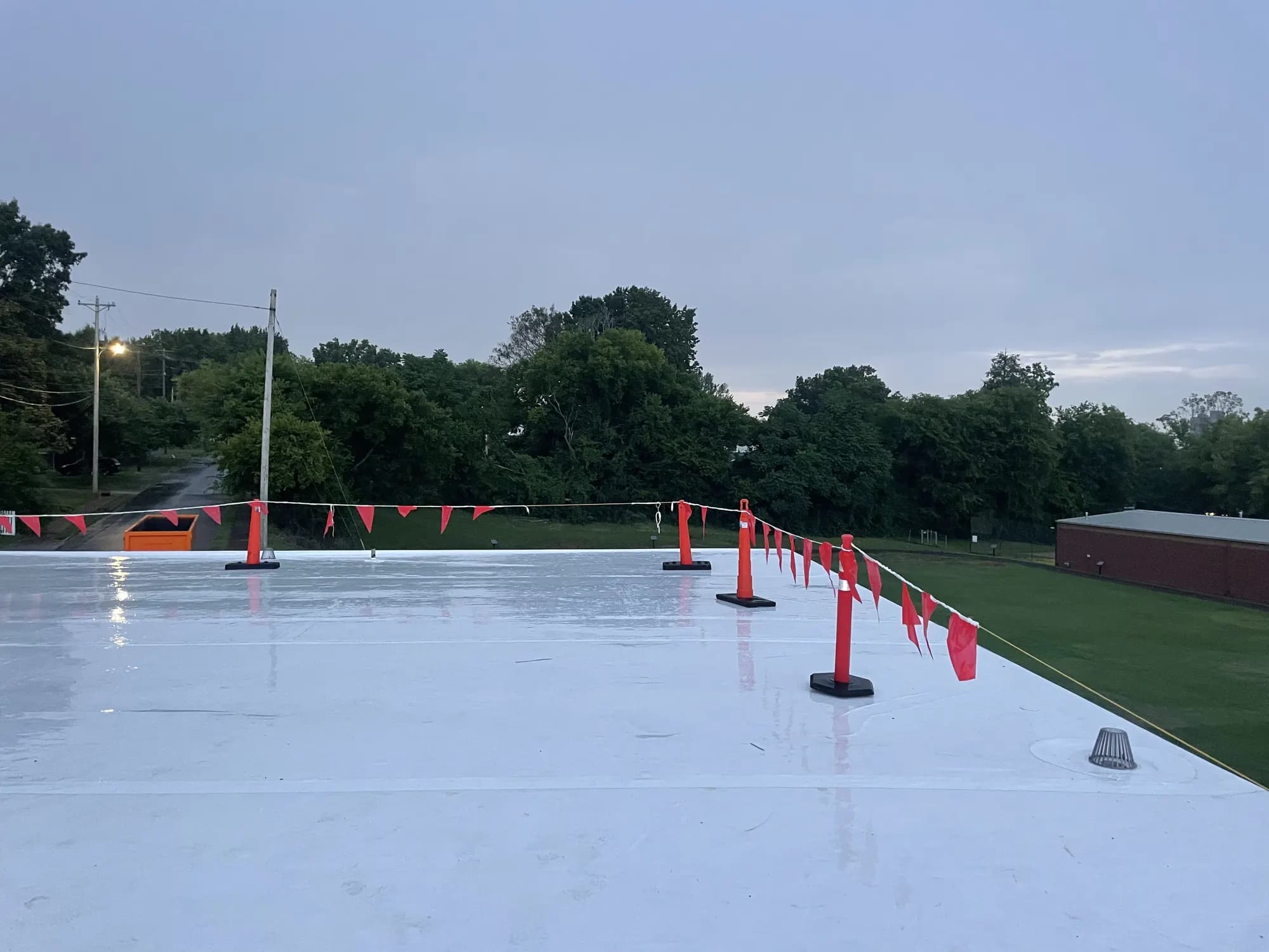 White TPO roof with a red safety flag line along the edge