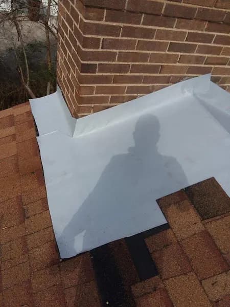 Rubber roofing membrane flashing installed around a brick wall, from our Knoxville office's job photos