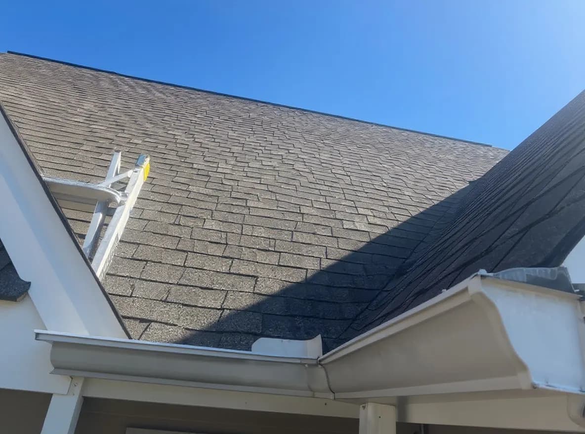 Roof of a home in Maryville, job photo: inspecting a roof for storm damage and replacing missing shingles