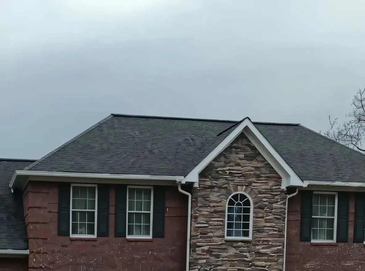 New 6-inch seamless gutters being installed along a roofline in Maryville, Tennessee