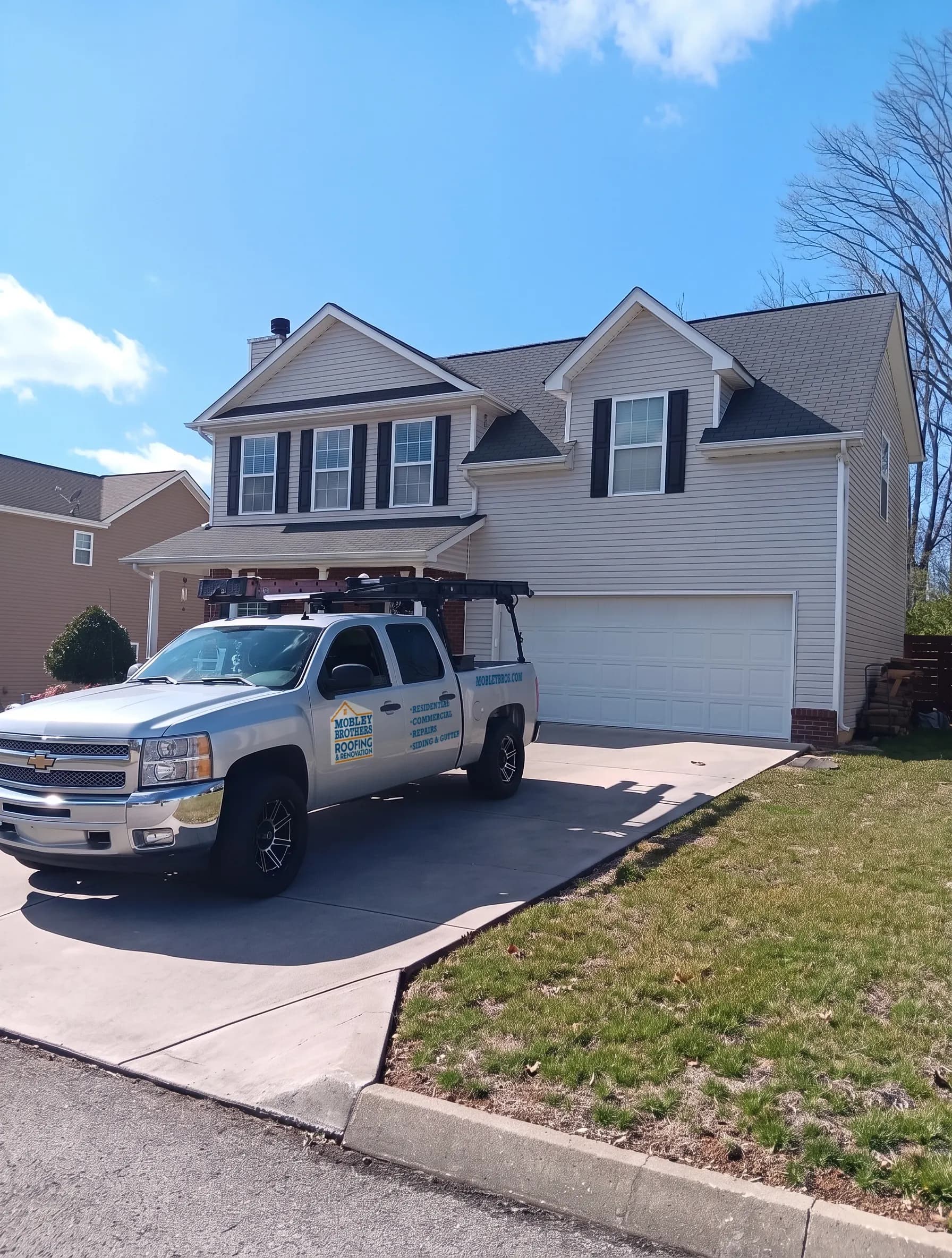Checking a roof for wind damage while helping a homeowner with a storm damage insurance claim in Powell, Tennessee