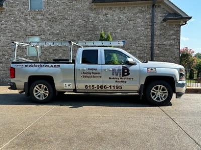Mobley Brothers Roofing and Renovation LLC truck in front of brick home in Knoxville that needs a home inspection