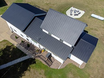 White home with steel roof in Nashville. Metal roofing is a popular choice for protecting your home. Schedule a visit with Mobley Brothers Roofing and Renovation LLC to explore available options.